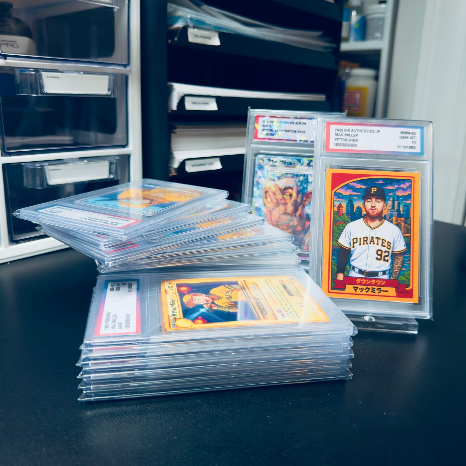 Collection of sports trading cards with protective sleeves on a dark surface.